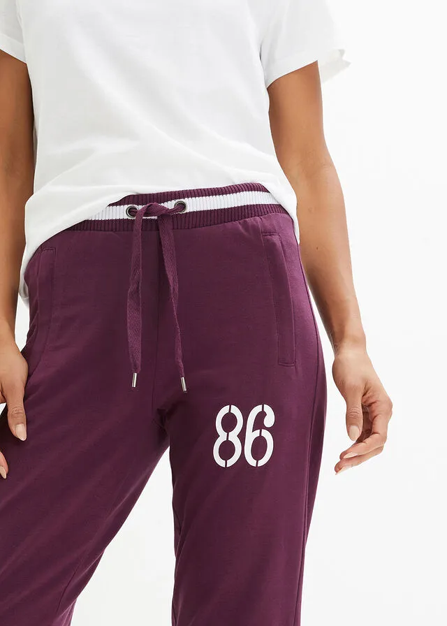 Pantalón deportivo con bolsillos con cierre morado intenso