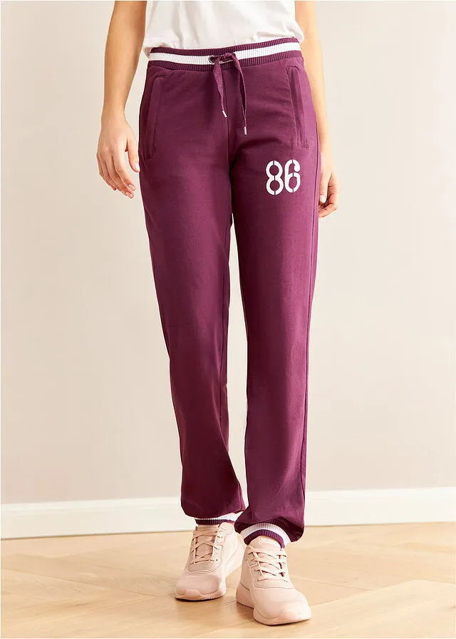 Pantalón deportivo con bolsillos con cierre morado intenso